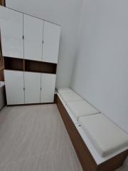Cozy bedroom with large wardrobe and cushioned bench