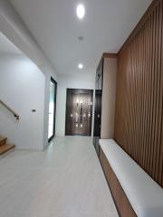 Modern hallway interior with wooden features and ample lighting