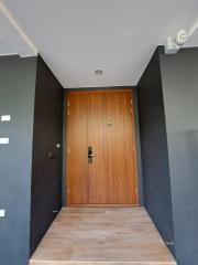 Modern home entrance with a wooden door and tiled floor