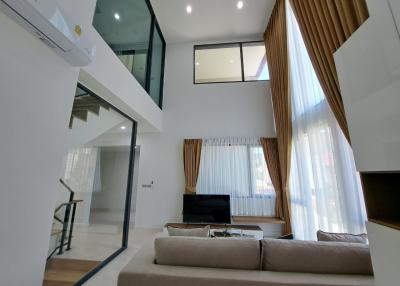 Spacious living room with high ceiling and modern design