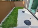 Small outdoor patio area with artificial grass