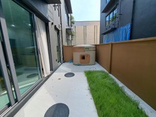 Modern home exterior with artificial grass and patio