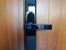 Modern digital lock installed on a wooden door