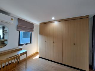 Spacious bedroom with built-in wardrobe and study area