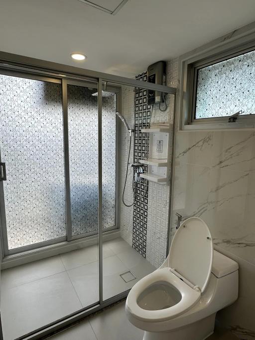 Modern Bathroom with Marble Tiles and Glass Shower