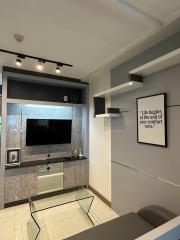 Modern living room with wall-mounted TV and inspirational quote