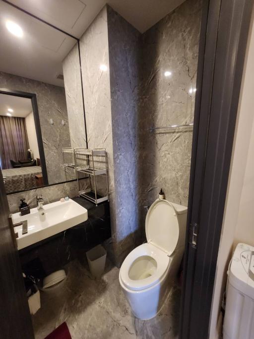 Modern bathroom interior with marble tiles and stainless steel fixtures