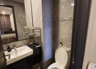Modern bathroom interior with marble tiles and stainless steel fixtures
