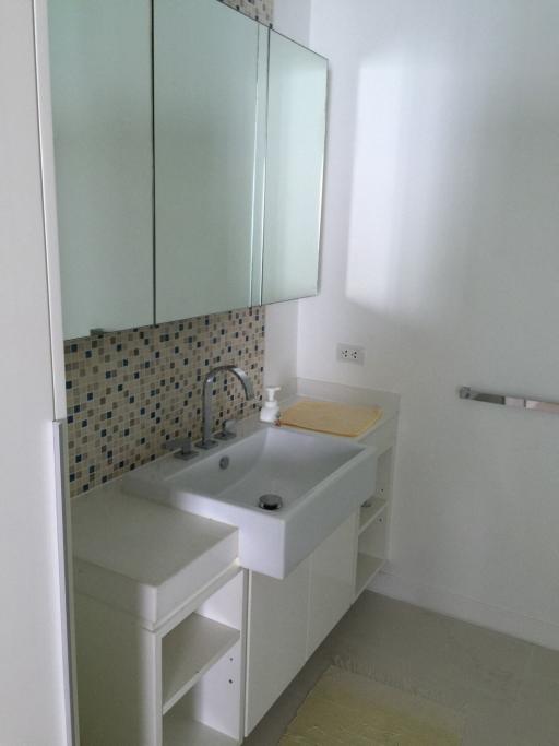 Modern bathroom with large mirror and white vanity