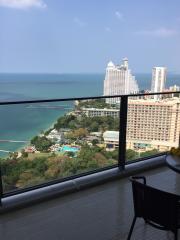 High-rise balcony overlooking the ocean with clear skies