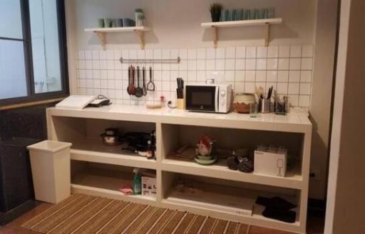 Modern kitchen with white tiling and open shelving