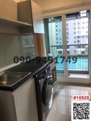 Modern kitchen with stainless steel appliances and balcony access