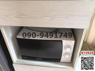 A modern microwave oven integrated in a kitchen shelf