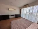 Spacious bedroom with large bed and ample natural light