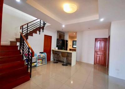 Spacious living room with staircase and open kitchen design