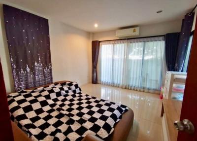 Cozy bedroom interior with tiled flooring and large window