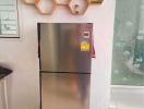 Modern kitchen with stainless steel refrigerator and unique hexagonal shelving