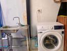 Utility room with sink and washing machine