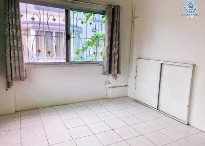 Bright and airy single bedroom with a large window and tiled flooring