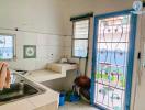 Spacious kitchen with natural light and storage cabinets