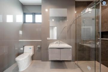 Modern bathroom with glass shower and neutral tones