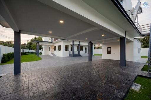 Modern house exterior with spacious carport and landscaped lawn