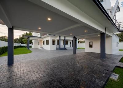 Modern house exterior with spacious carport and landscaped lawn