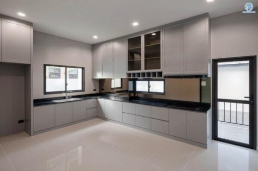 Modern kitchen interior with clean countertops and grey cabinetry