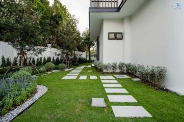 Well-maintained garden with stepping stones leading to a modern house