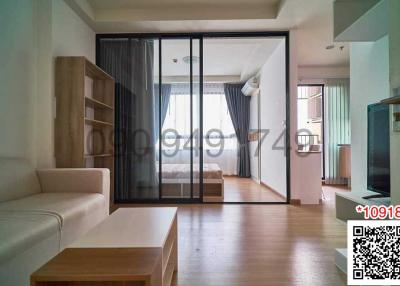 Bright and modern living room with open sliding doors to adjacent room