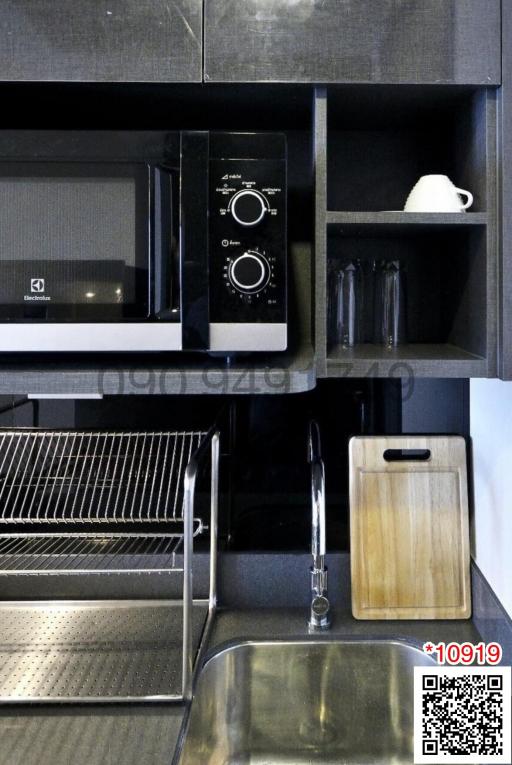 Modern kitchen interior with black cabinets and stainless steel sink