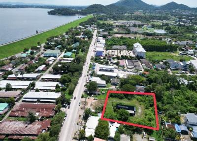 Aerial view of a residential plot near a road with scenic landscape