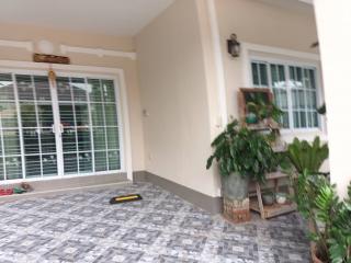 Spacious covered patio with patterned tile flooring and natural light