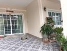 Spacious covered patio with patterned tile flooring and natural light