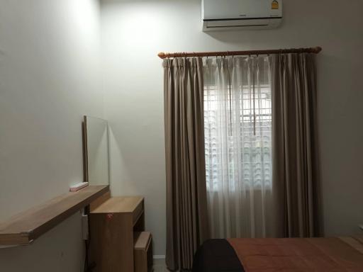 Cozy bedroom with air conditioning and natural light