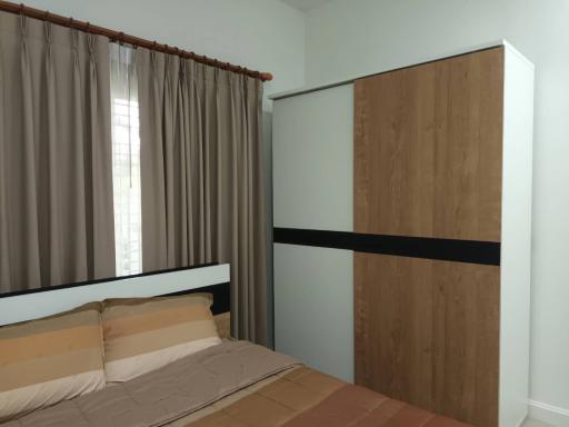 Modern bedroom with a large bed and wooden wardrobe