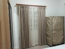 Cozy bedroom with neutral-toned curtains and natural light