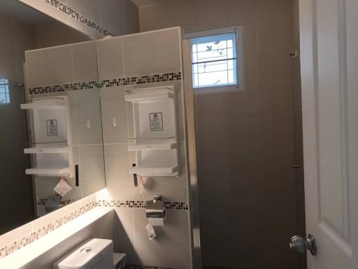 Modern bathroom interior with built-in vanity unit and small window