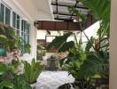 Lush patio area with potted plants and comfortable seating under a pergola