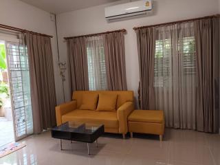 Bright modern living room with a yellow sofa