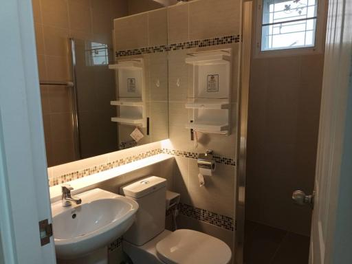 Compact bathroom with tile decor and essential fixtures