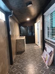 Well-lit corridor with decorative tile flooring and modern aesthetic