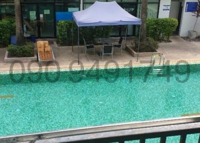 Apartment complex with outdoor pool and seating area