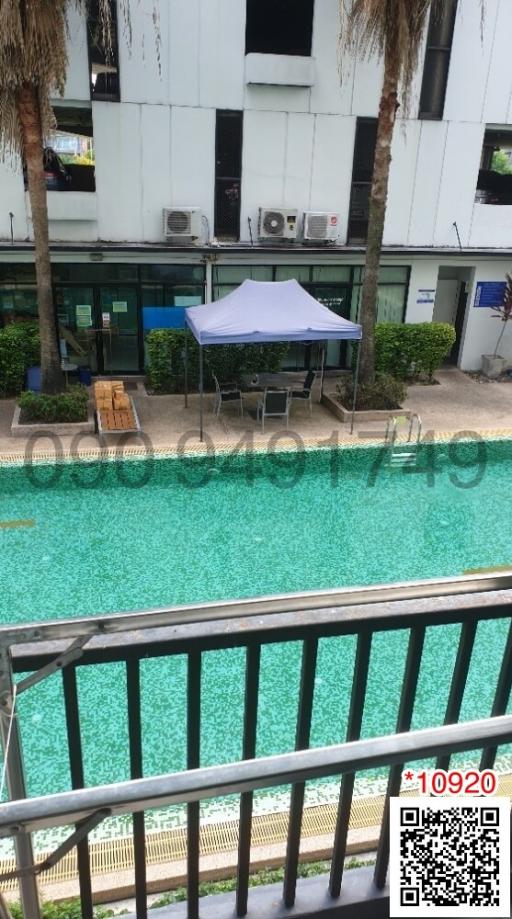 Apartment complex with outdoor pool and seating area