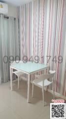 Modern dining area with a white table and chairs