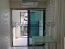 Bright and airy living room with glass door leading to a balcony