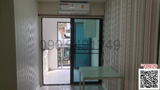 Bright and airy living room with glass door leading to a balcony