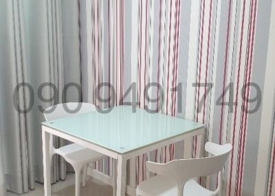 Modern dining space with table and chairs and striped curtains