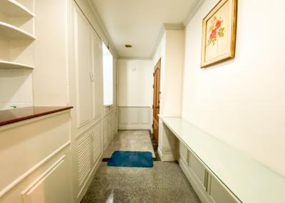 Bright and welcoming hallway interior with tiled flooring and wall decor