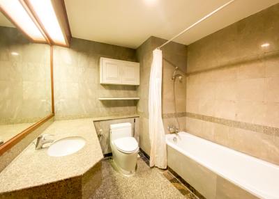 Spacious bathroom with bathtub and elegant finishes